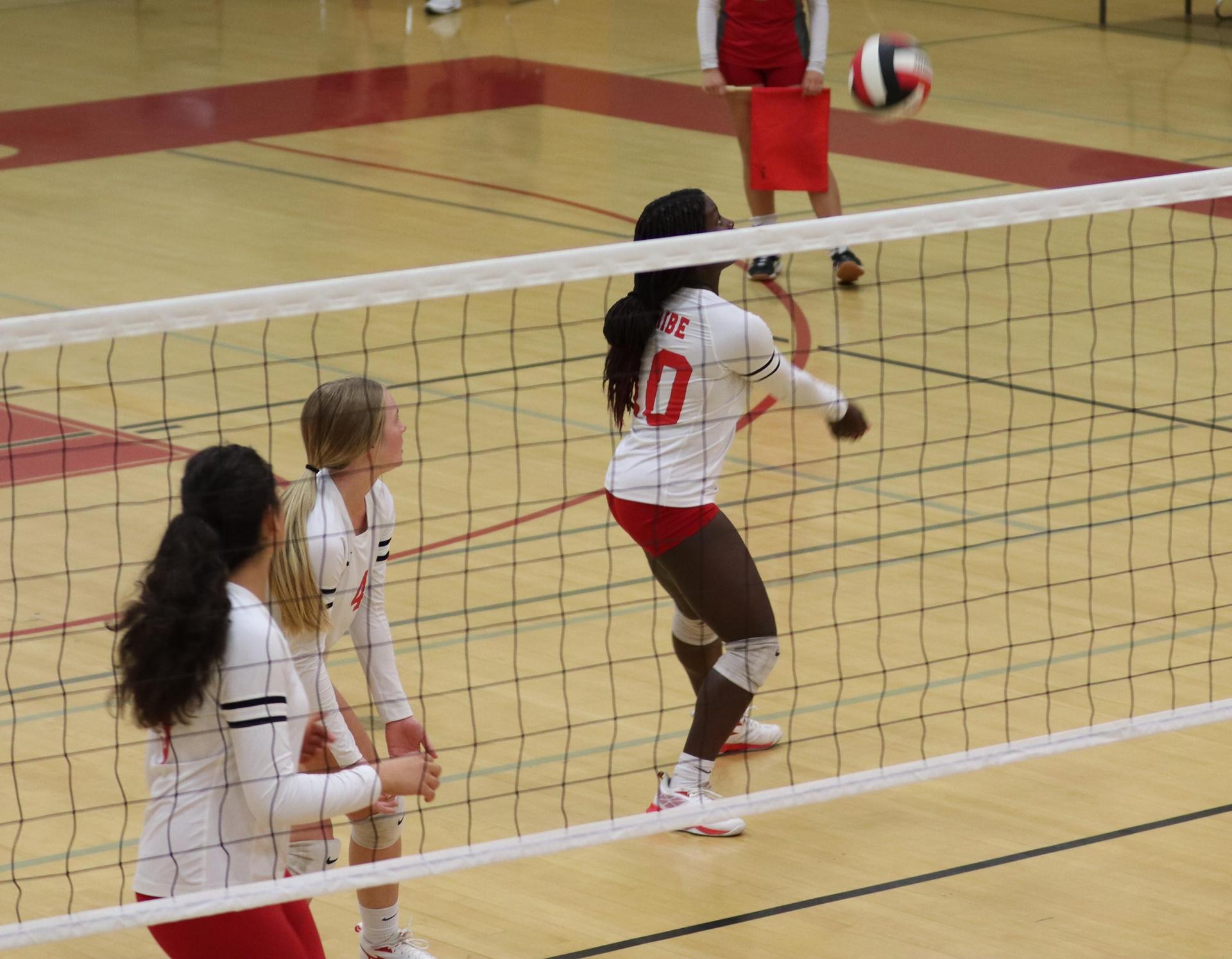 varsity volleyball players in action against Fresno Christian