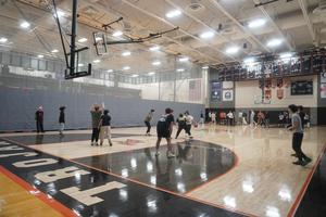 Students playing basketball in the gym.
