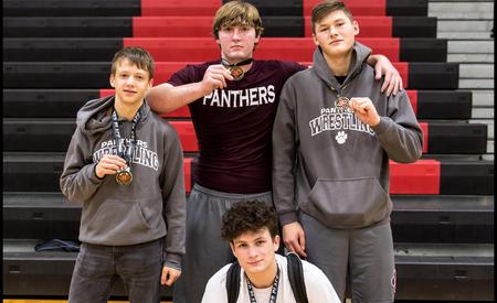 picture of boys with wrestling medals