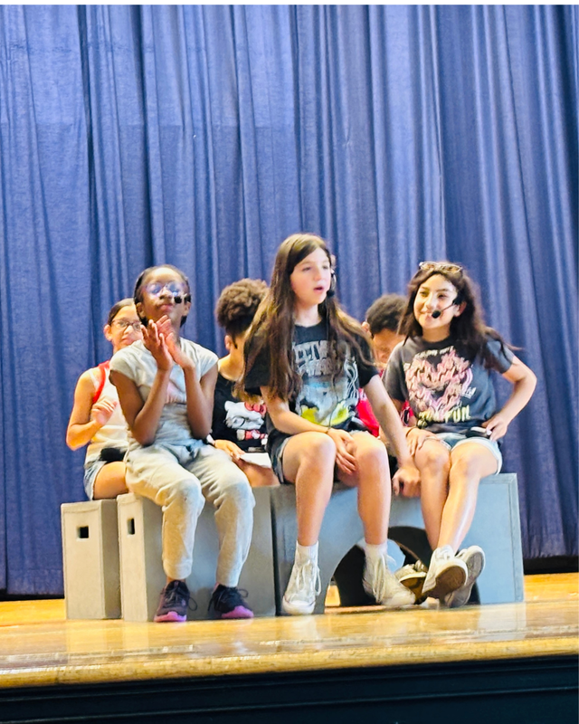 Students deliver project through a performance on stage