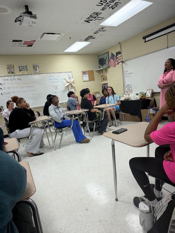 Students listening to Ms. Elzie share her story