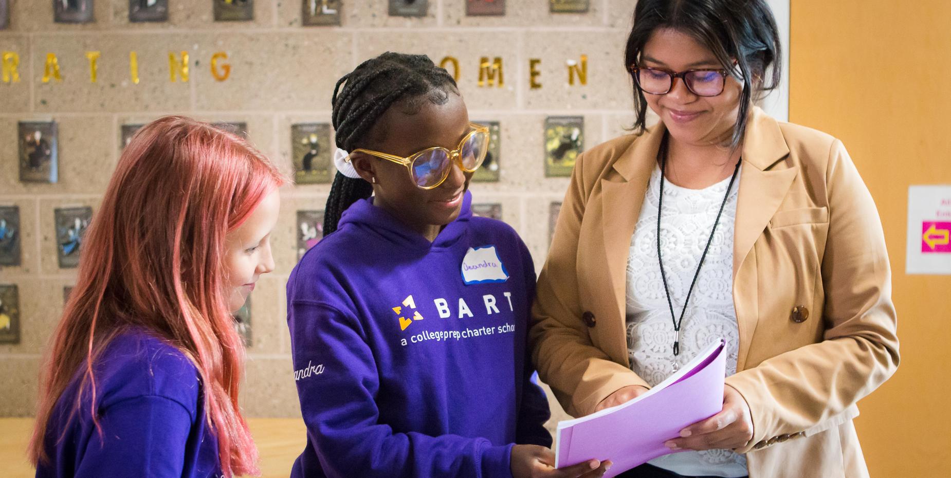 Ms. Hang talks with 2 students