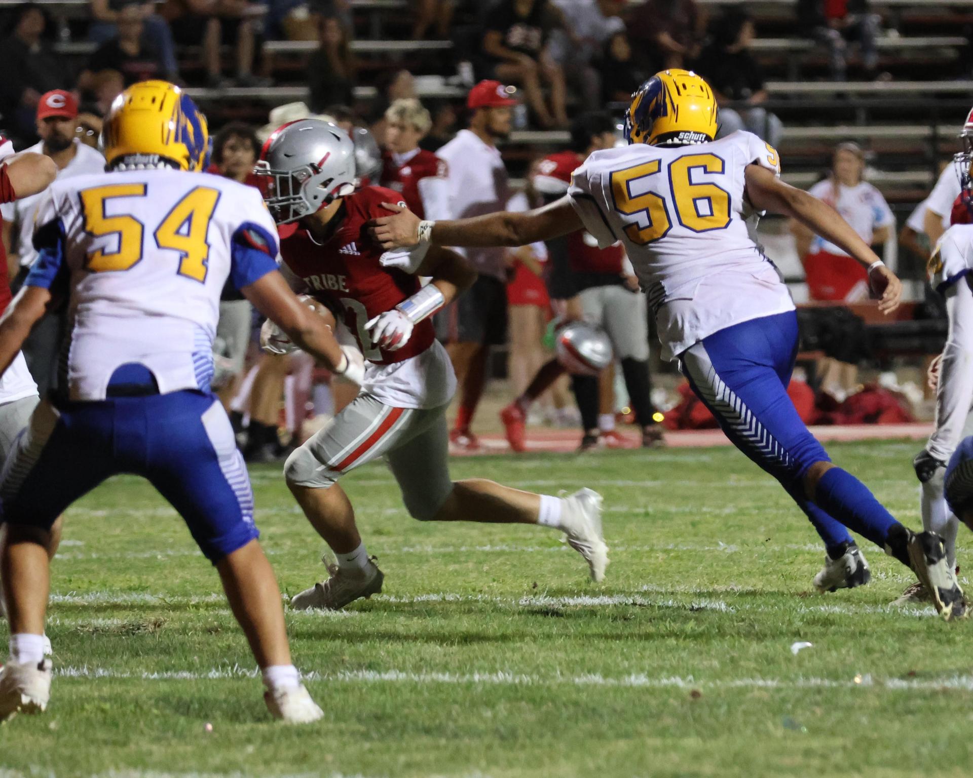 Varsity football players in action against Parlier 87