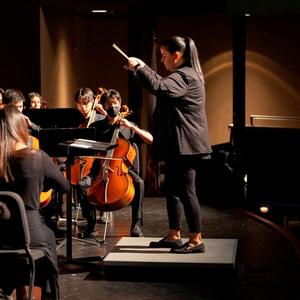 Band director Melissa Romero conducting the high school orchestra