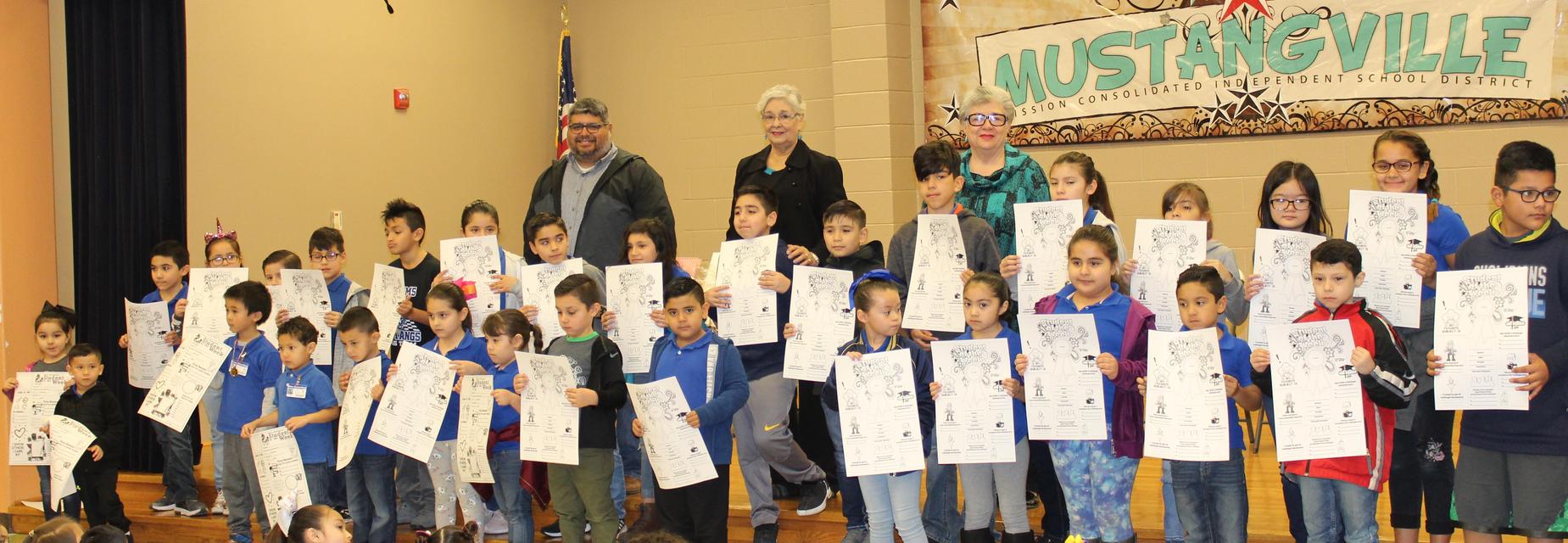 students with Student of the week posters and school board members