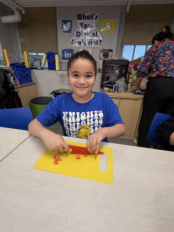 student cutting vegetables