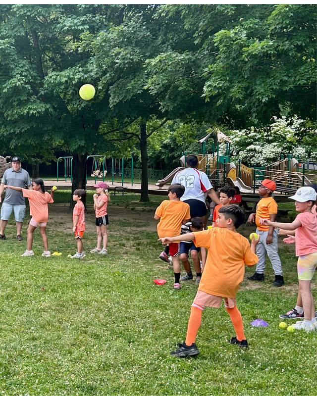 Students on field throwing balls