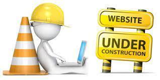 Website under construction with a stick figure construction worker working on a laptop.
