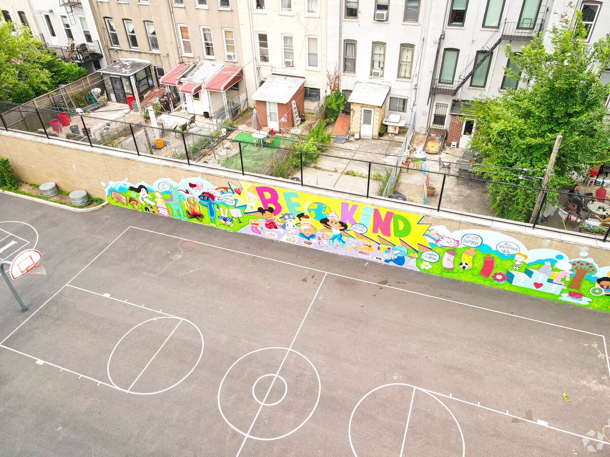 playground with mural that shows "Be Kind"