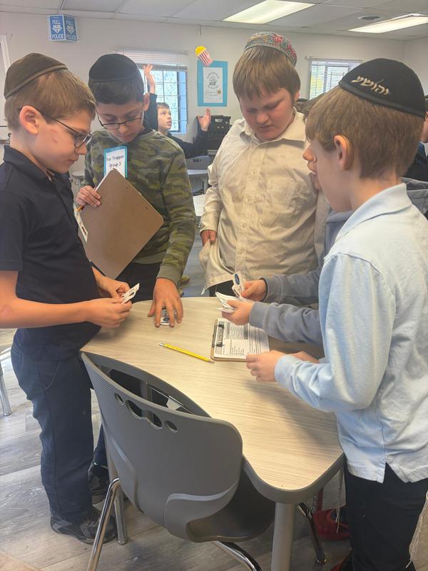 Fifth grade boys practice bartering skills.