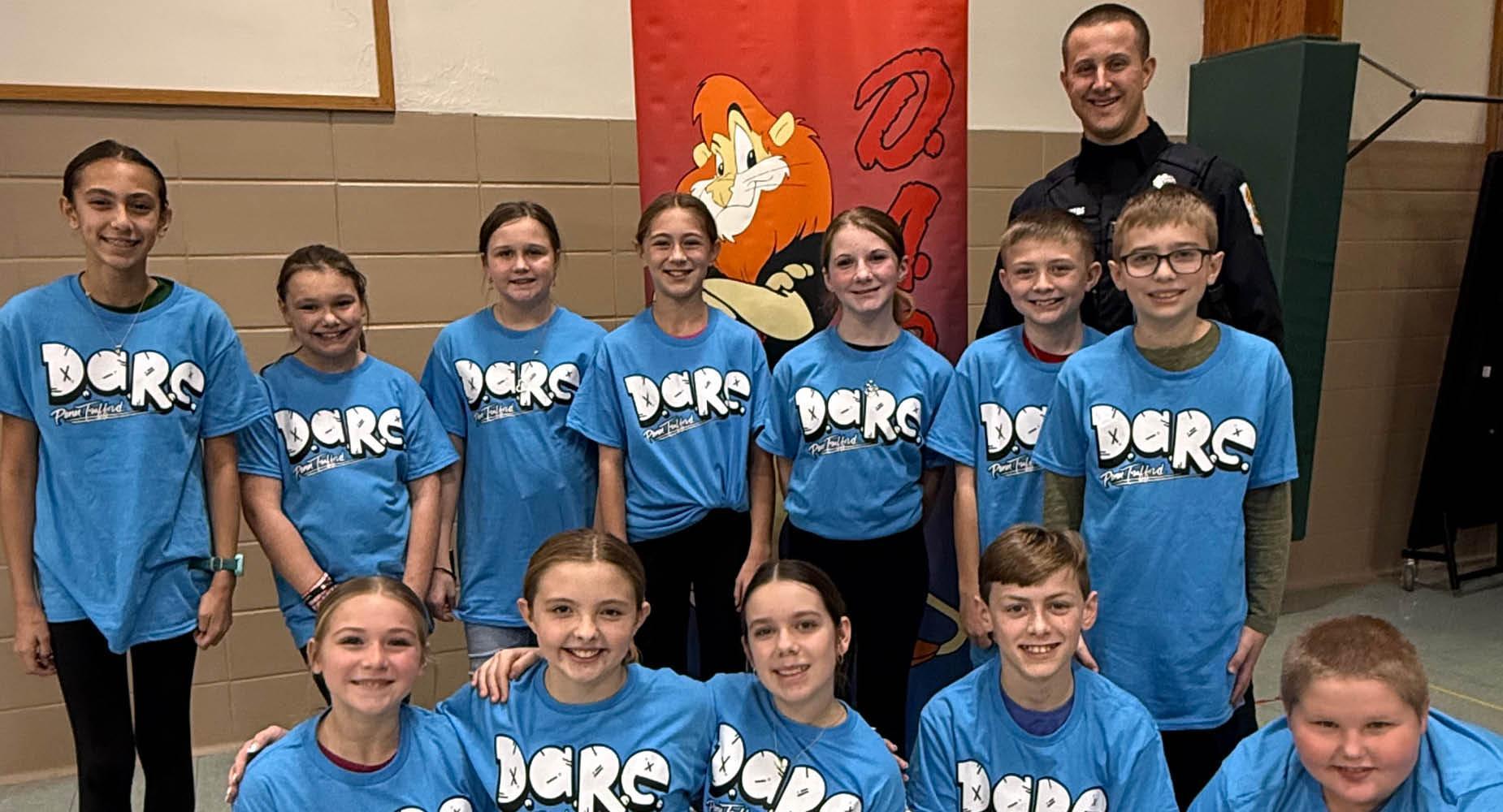 Sunrise 5th-graders celebrate completing the DARE program with Office Meyers