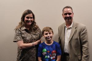 VAMS Principal Dr. Jessica Fair and Harrison Bausell pose with Dr. Brown after Harrison explained his new club to the board.