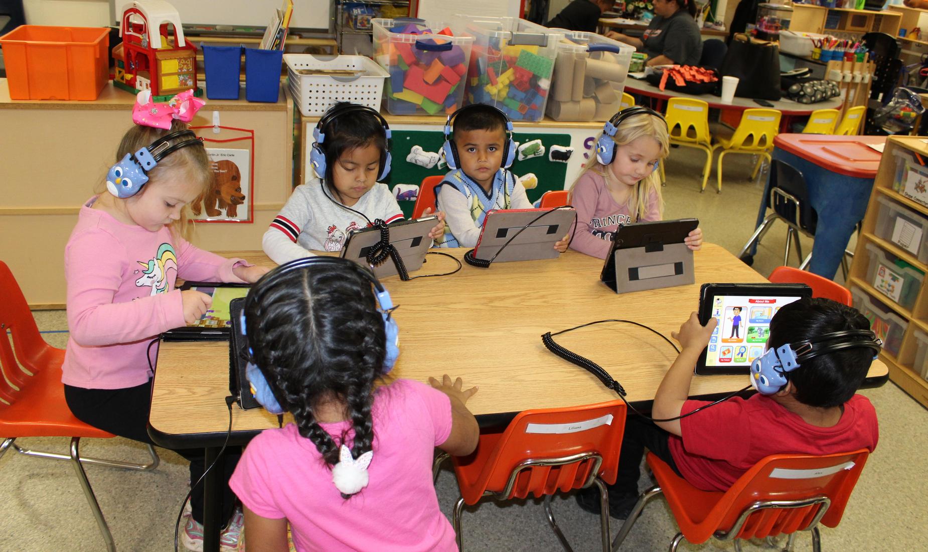 PreK students working on ipads