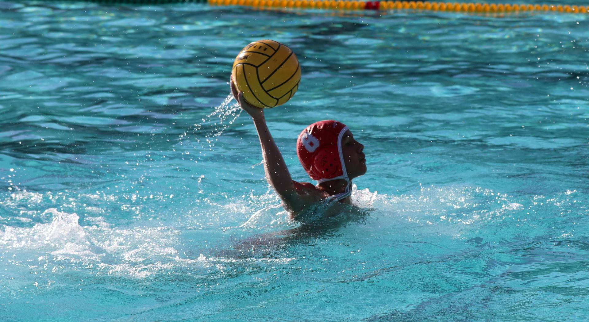 boys water polo players in action against hoover