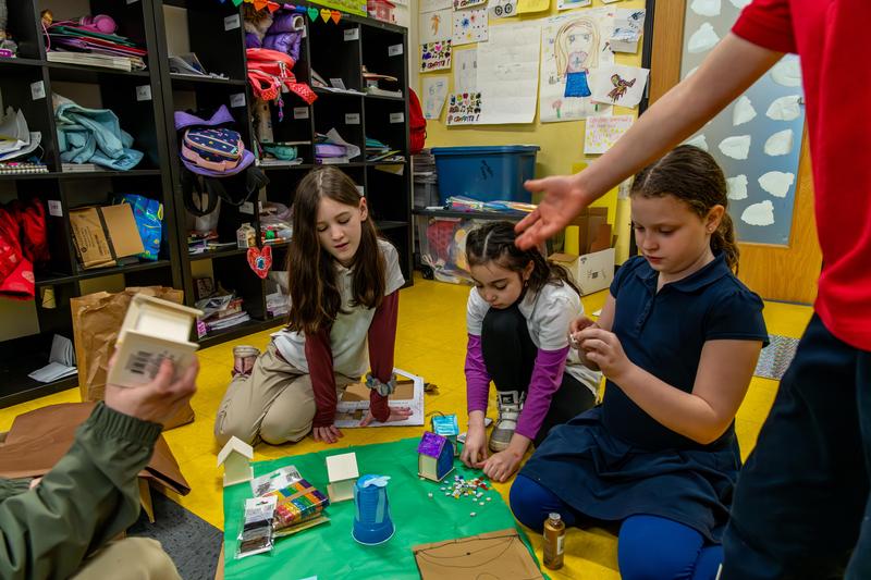 Arco Iris students work on a group hands-on project in their classroom.