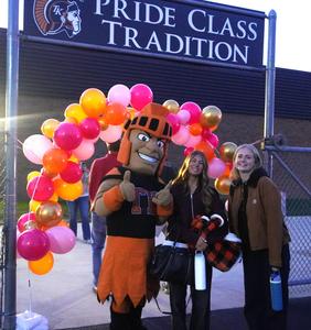 TK Trojan and students pose for photo as they enter the stadium.