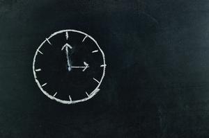 Chalkboard with a clock drawn on it