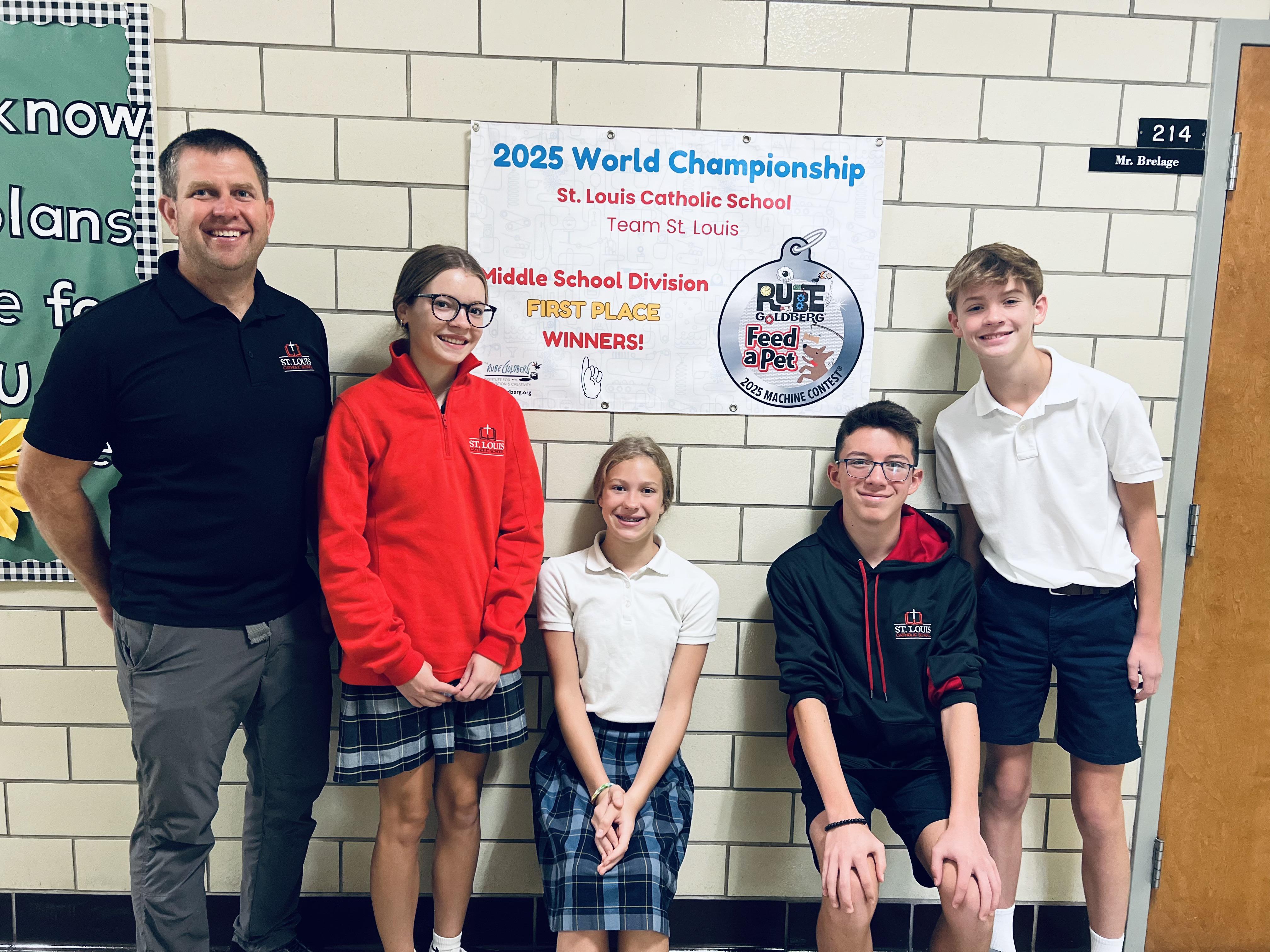 Members of the Rube Goldberg team pose with their championship poster.