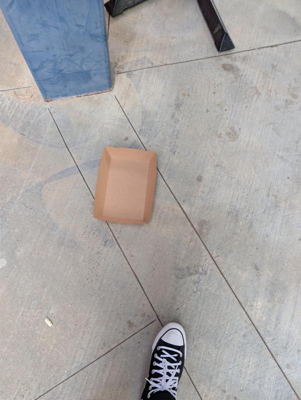 Tray trash is left on floor