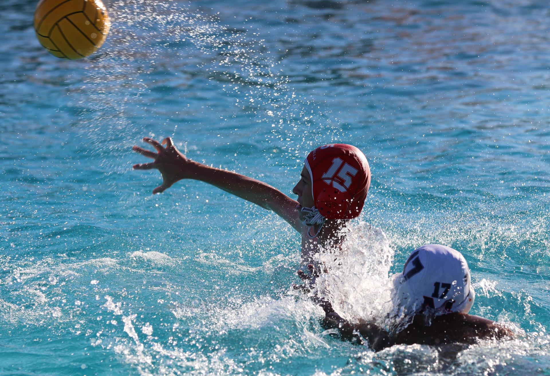 boys water polo players in action against san joaquin memorial
