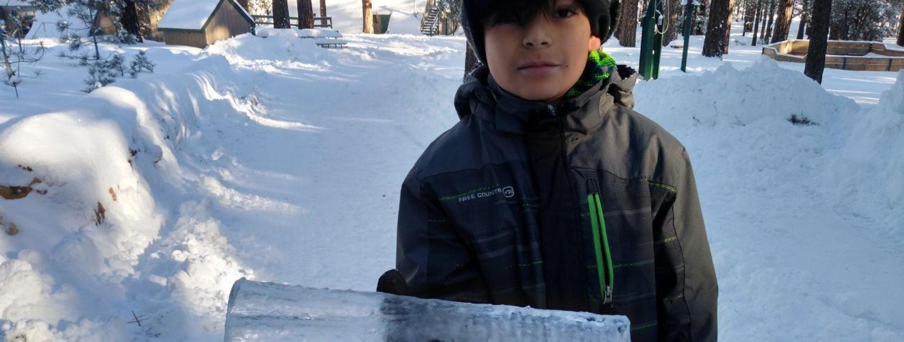 boy hold a giant icicle