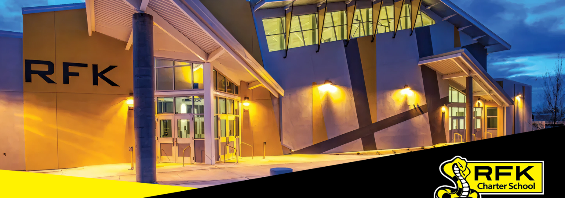 Exterior of RFK Charter School building at dusk with modern architecture.