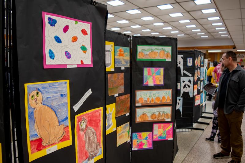 Attendees at the 2025 Spring Fling explore the expansive student art gallery.