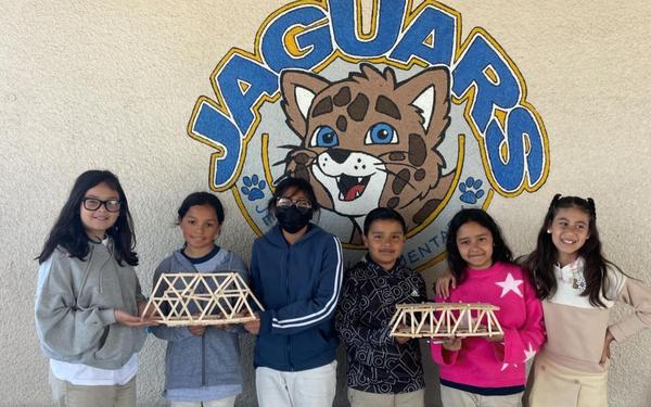 students with stick bridge