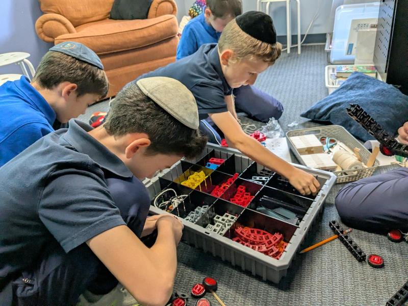 Fourth grade students in enrichment familiarize themselves with the robotics kit.