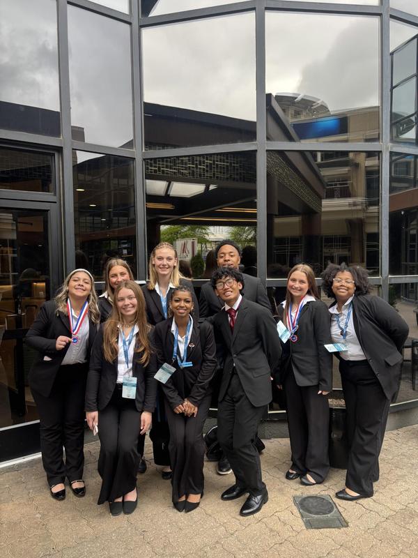 Smiling teens dressed in professional attire