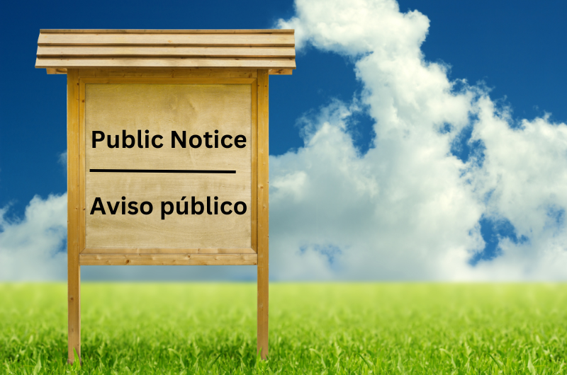 Public Notice sign with a blue sky background.