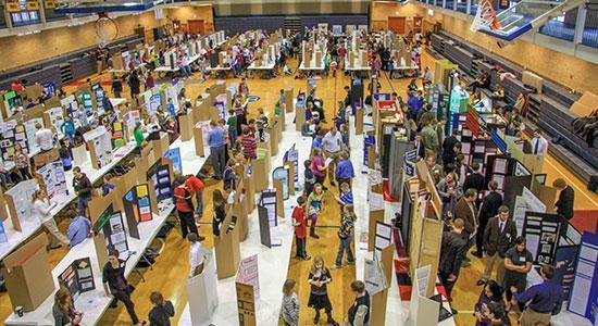Students showing their science fair certificates