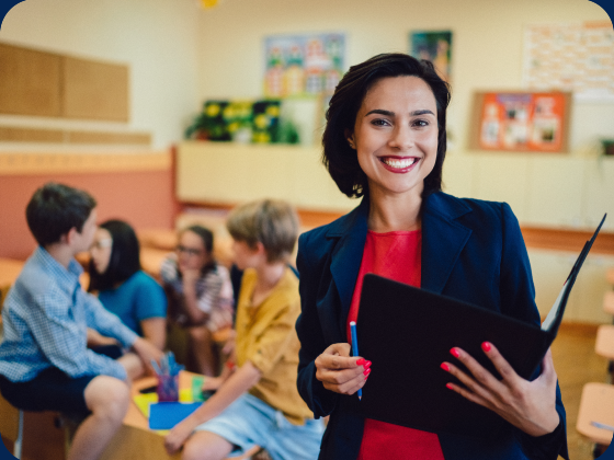 Teacher smiling in classroom with students