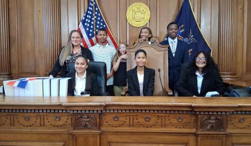 MS 180 mock trial team on sitting on the bench