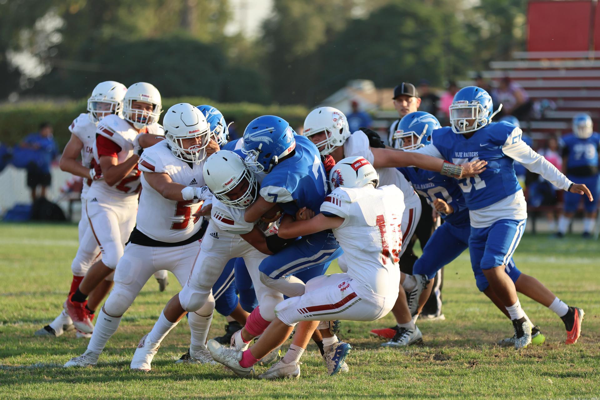 Junior Varsity football players in action against Caruthers