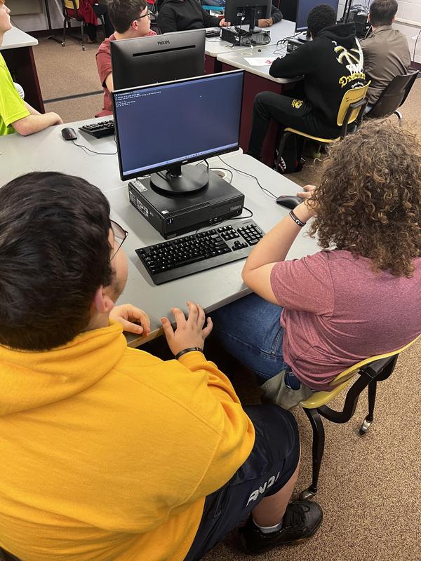 Students try break a code in IT class