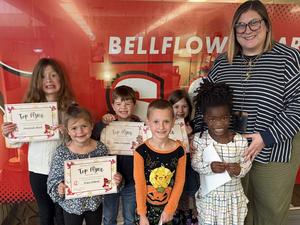 Students holding certificates with the principal.