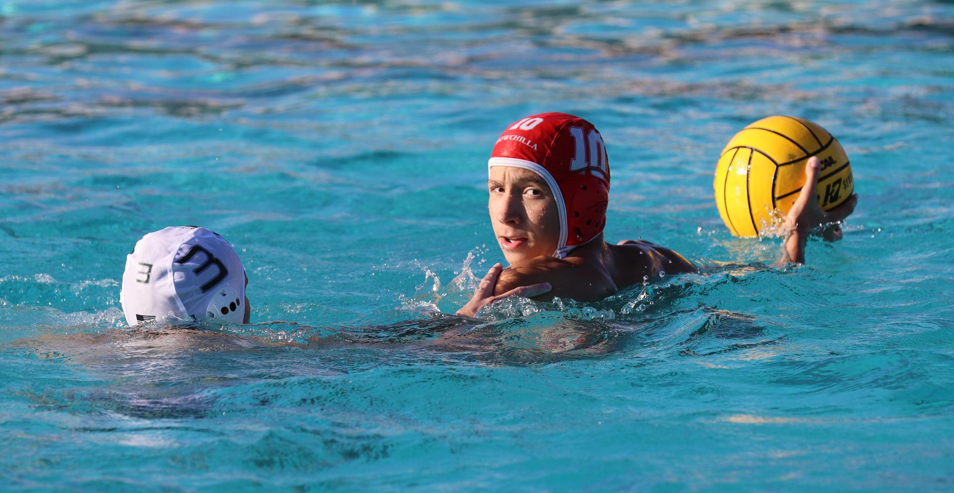boys water polo players in action against hoover