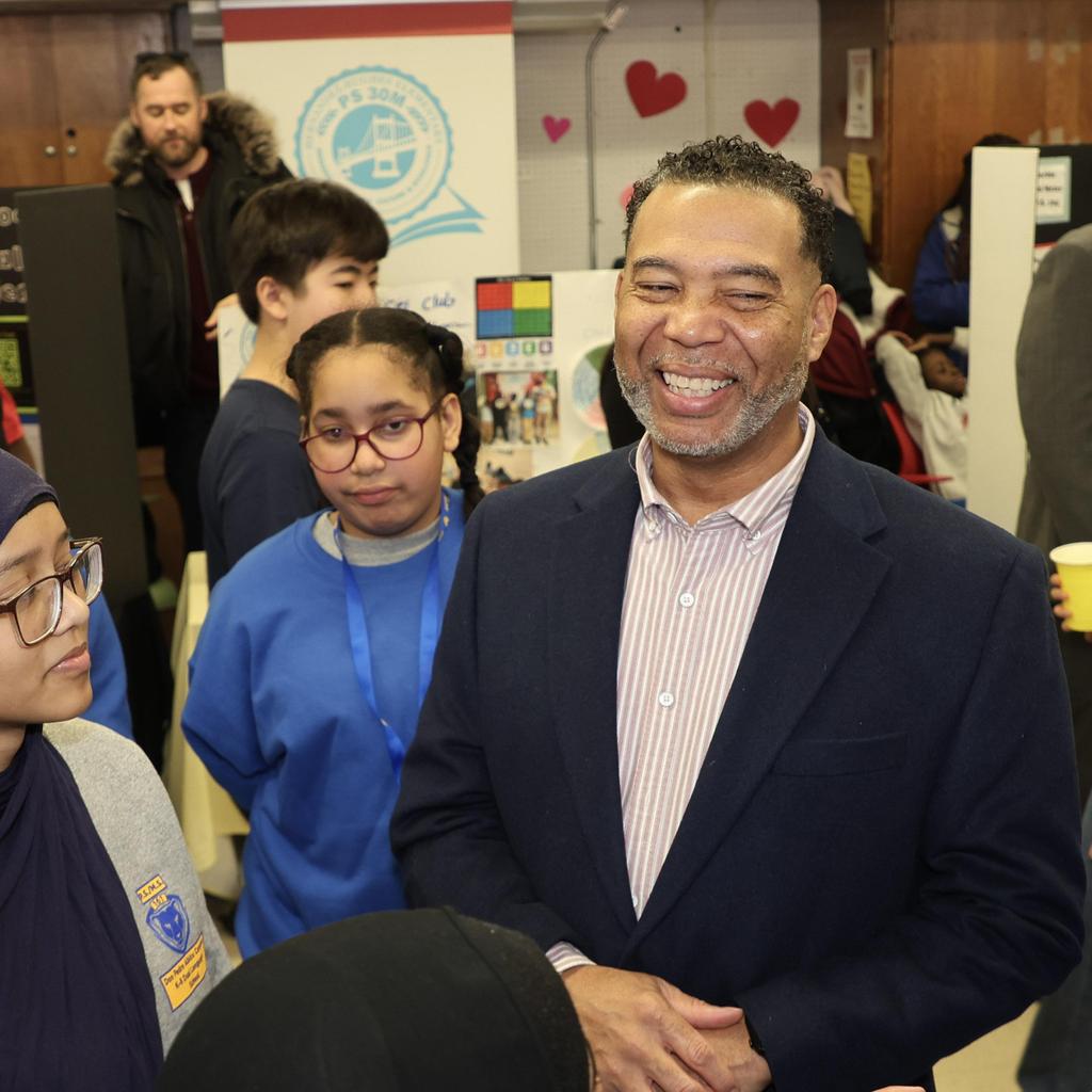 Superintendent smiling with students