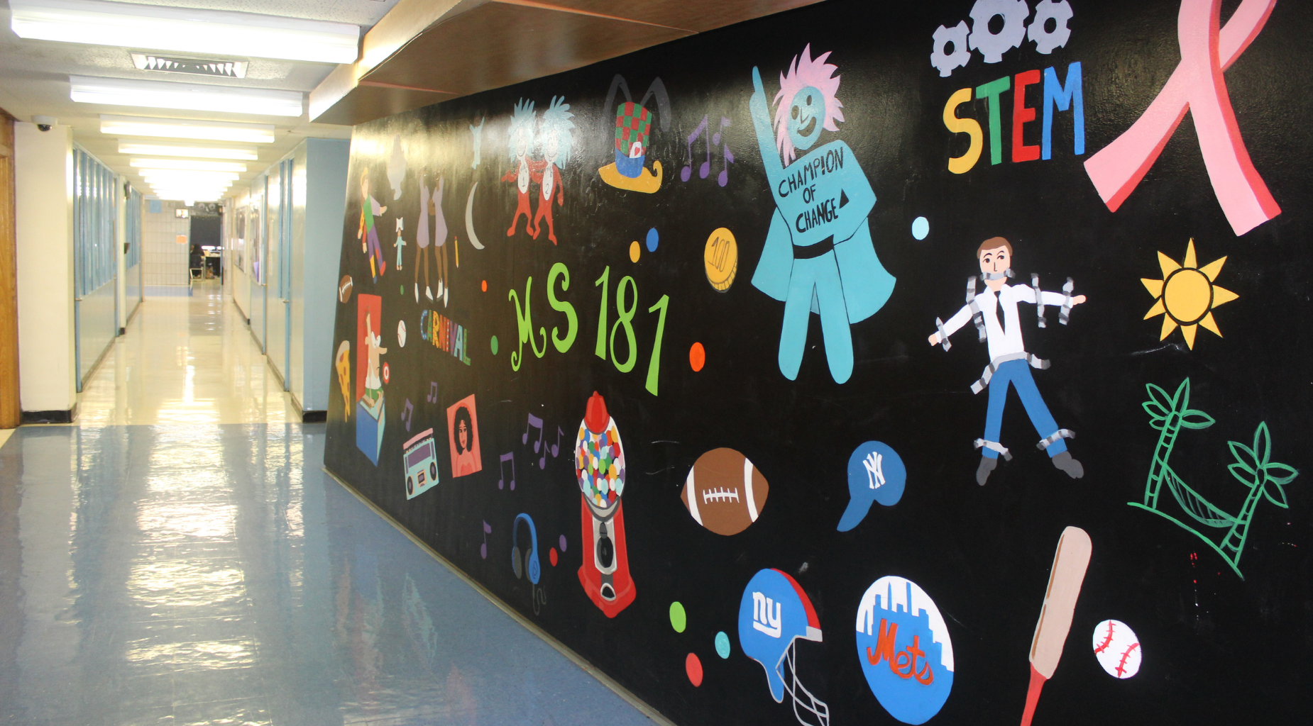 Colorful mural on a school hallway wall showcasing various themes.