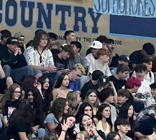 students in the bleachers in the gym