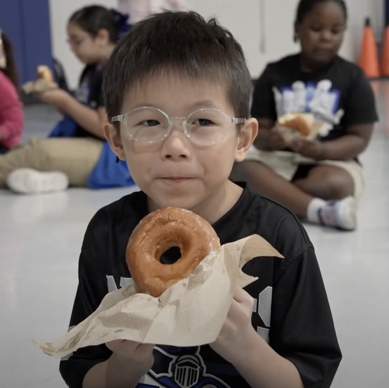 Canterbury kid eating a doughnut