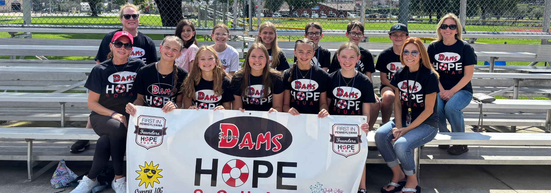 Group photo of DAMS Hope Squad members holding a banner.