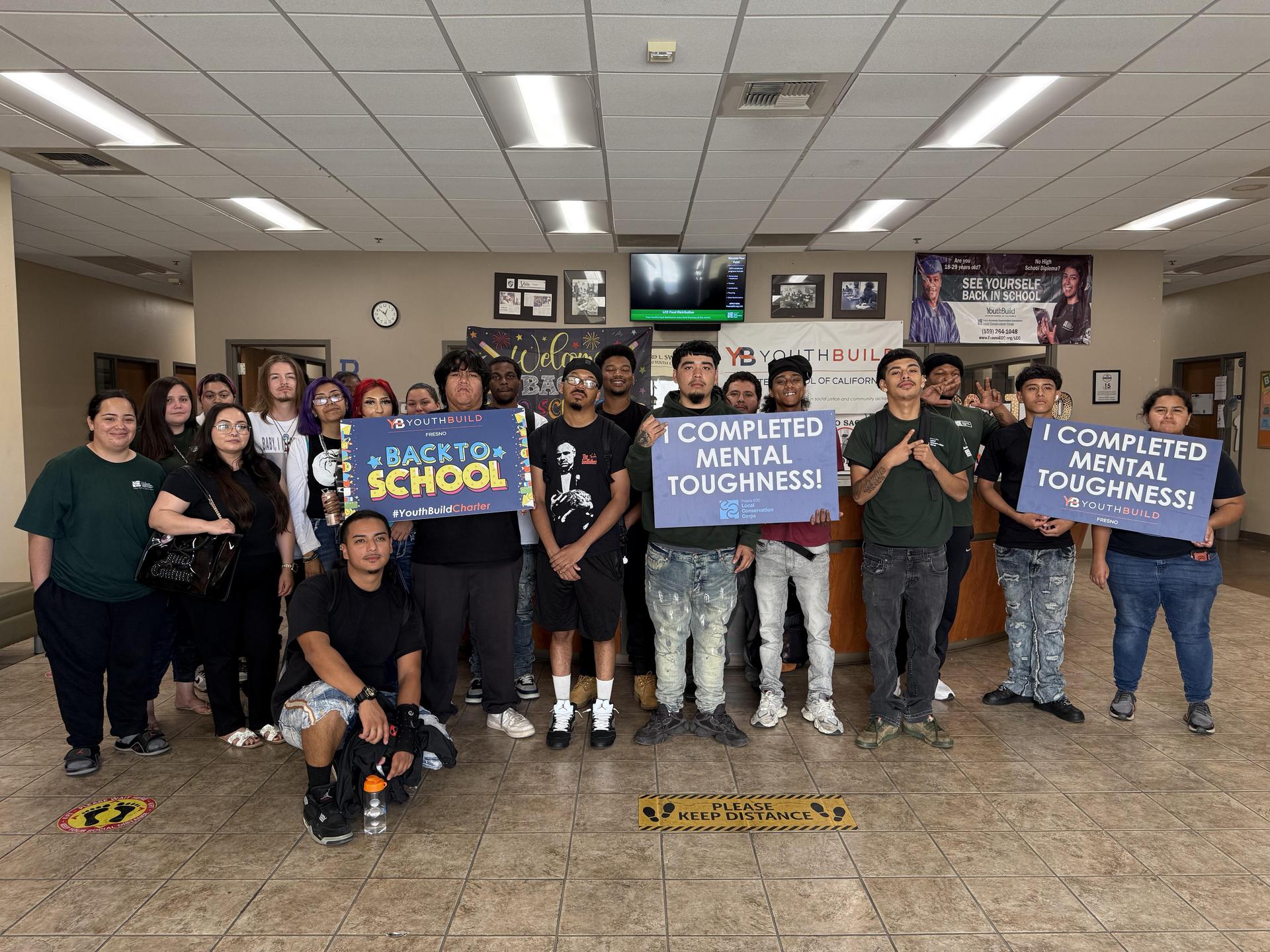 students from the Fresno site holds signs