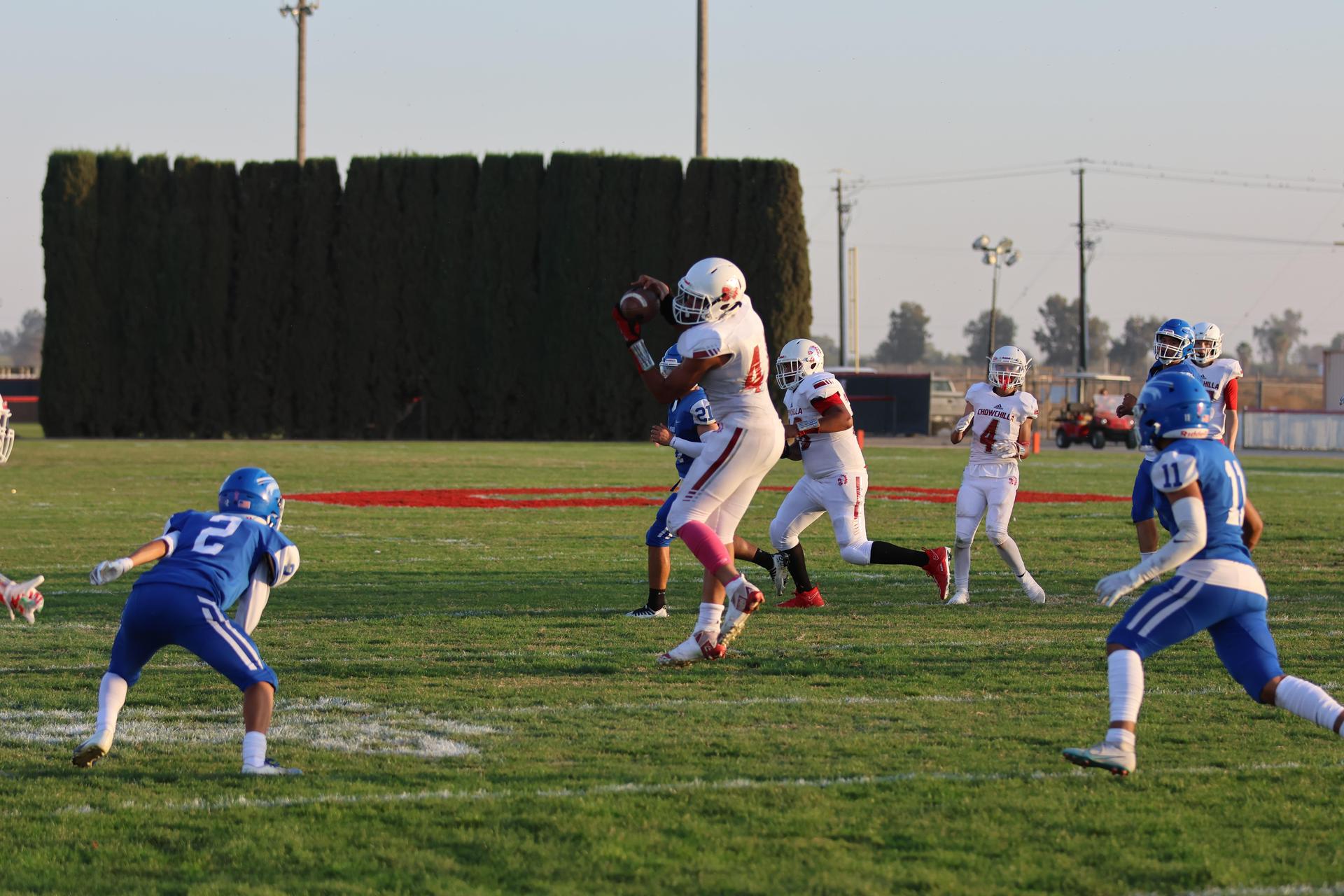 Junior Varsity football players in action against Caruthers
