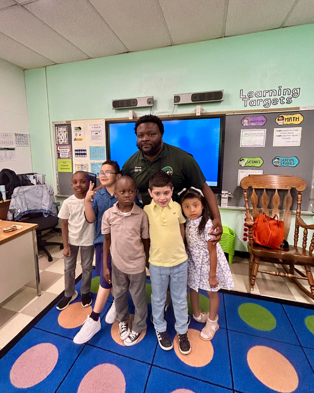 Students poses with LFJ staff member, Mr. Carney