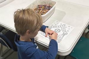 Kindergartener Luca Marts enjoys the coloring station during Trafford Elementary's game day