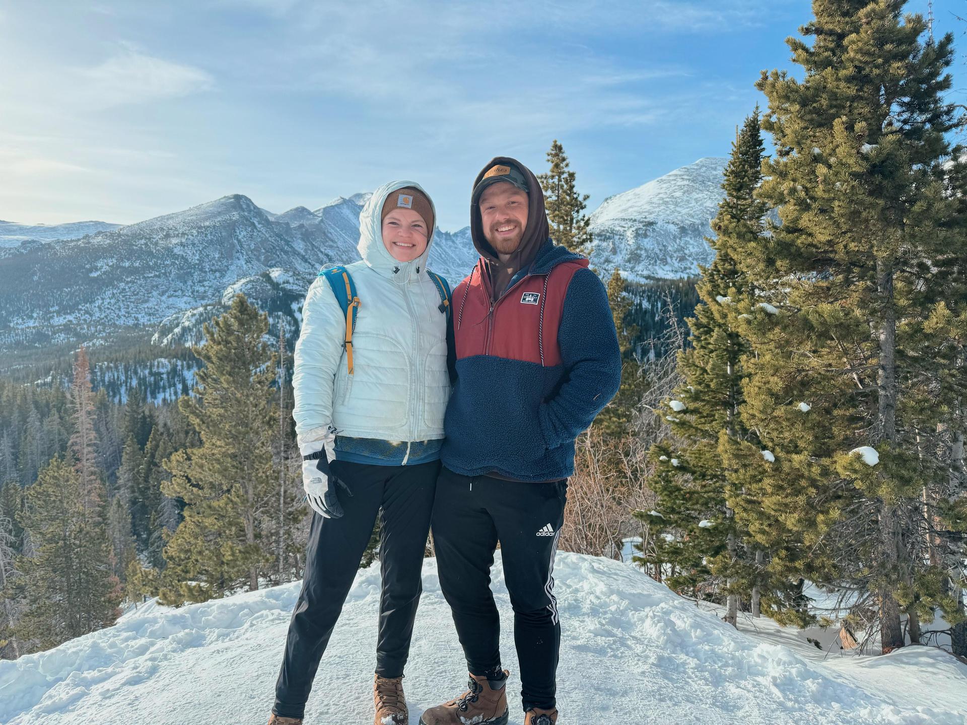 Mrs. Meline and her husband standing on top of one of Colorado's mountains.