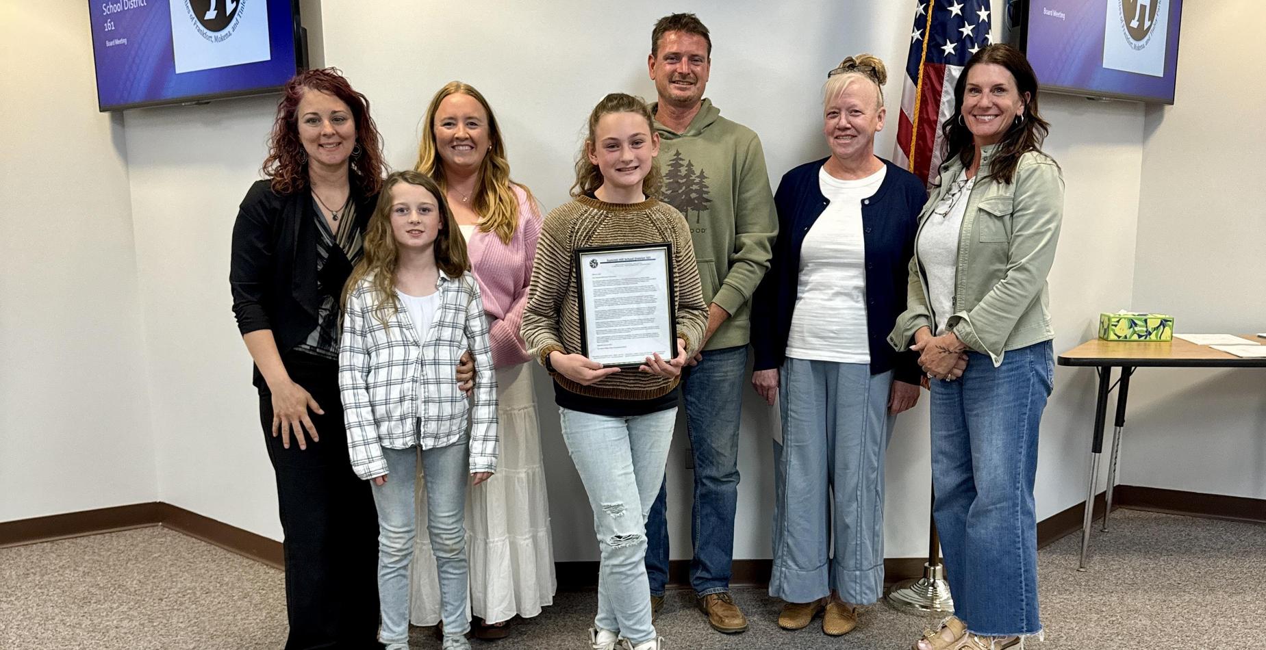 A group photo of the Hilda Walker Intermediate School Exemplary Student with her family and some Summit Hill School District 161 staff members after being recognized at the May Board of Education Meeting.
