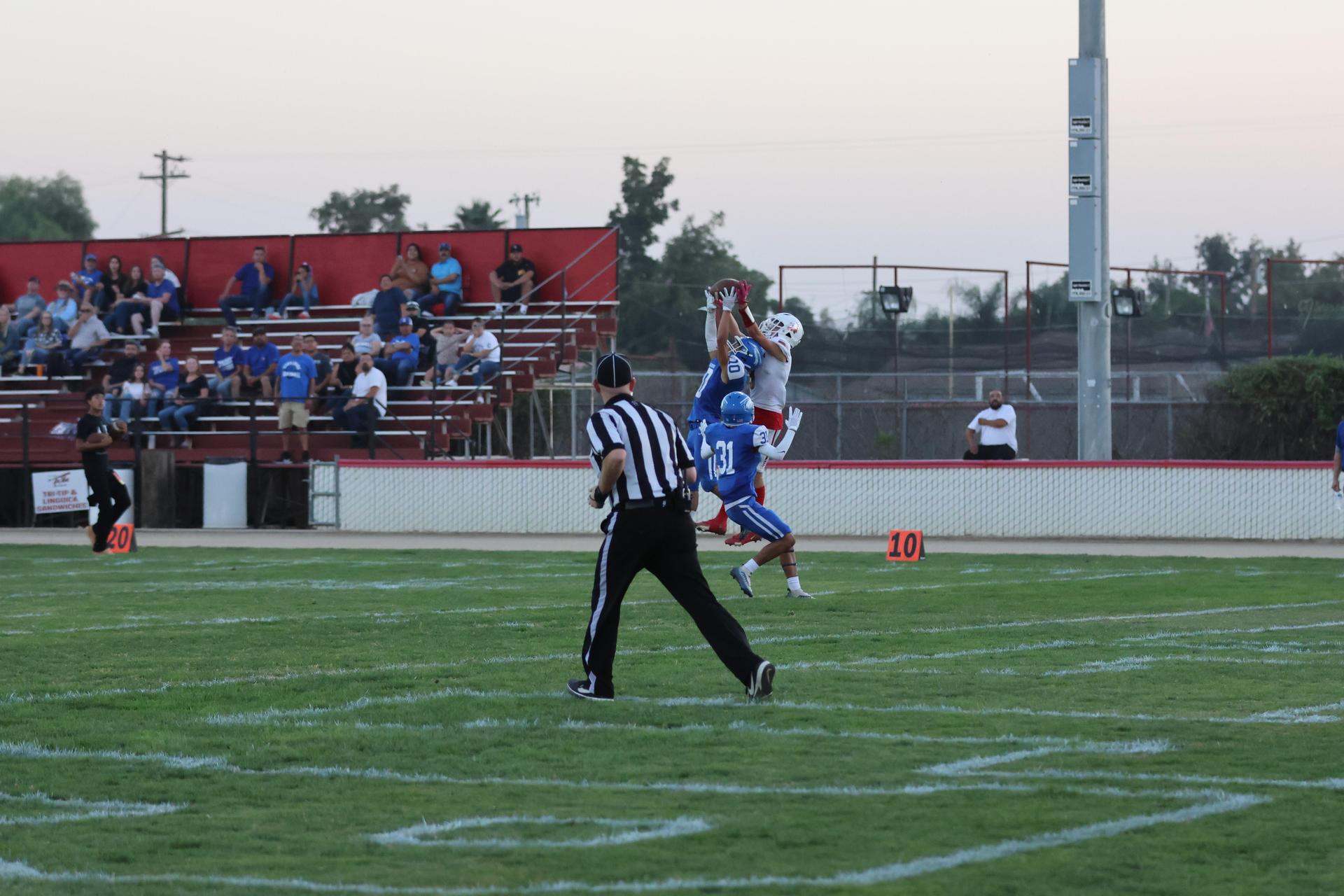 Junior Varsity football players in action against Caruthers
